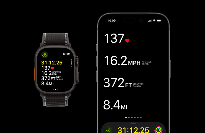 Apple Watch Ultra 3, musta väri, titaanikuori, Trail Loop ‑ranneke, värinä musta/hiili, iPhone, käynnissä olevan treenin tiedot avoinna kummallakin laitteella